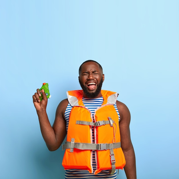 Depressed sorrowful black man feels unhappy to loose water battle game