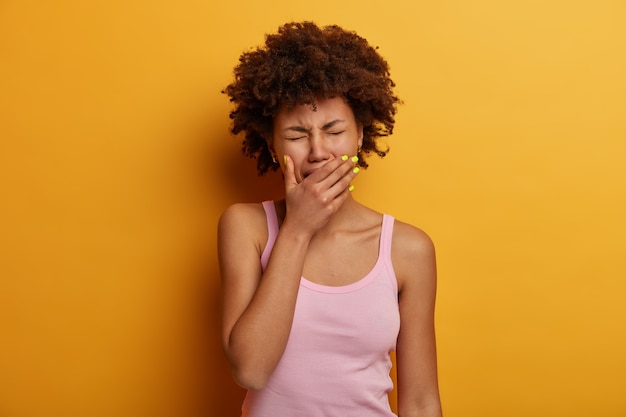 Depressed woman experiences painful moment, cries as finds out tragic news, covers mouth with palm, has sad expression, needs support in difficult life situation. People, negative emotions, feelings