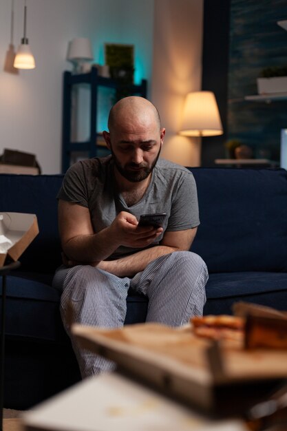 Depressed worried man reading renter notification for unpaid bank bills news