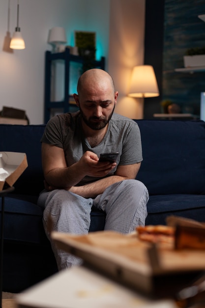Depressed worried man reading renter notification for unpaid bank bills news