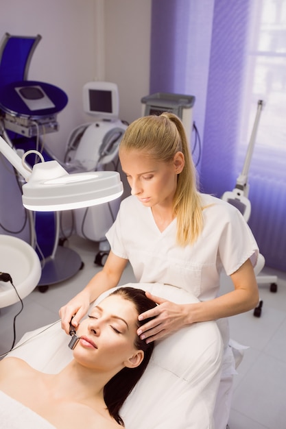 Free photo dermatologist performing laser hair removal on patient