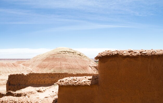 Desert landscape with ruins under blue sky