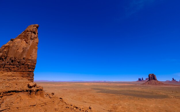 Desert with cliffs and dry filed with clear blue sky