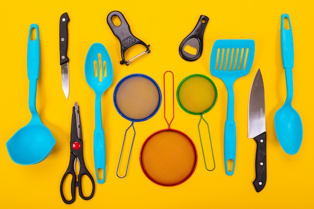 Design concept of kitchen utensils isolated on yellow