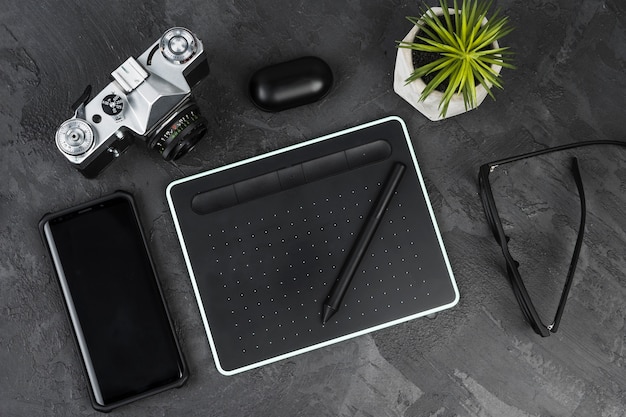 Desk arrangement on slate background top view