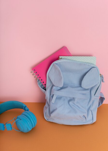 Desk arrangement with backpack and headphones