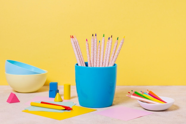 Free photo desk arrangement with bowls and pencils