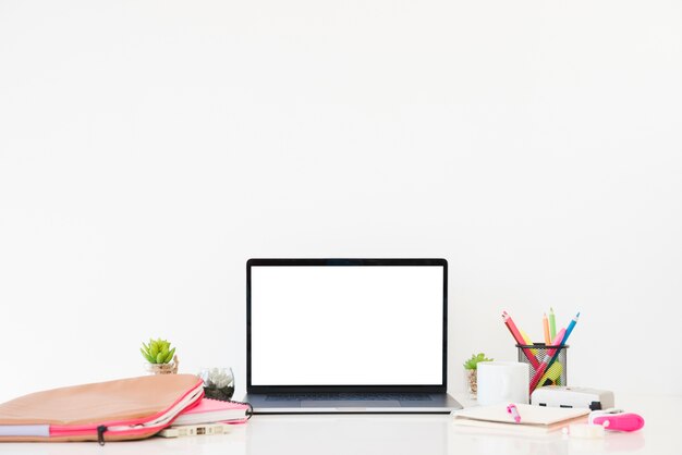 Desk arrangement with laptop and notebook