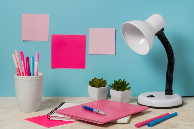 Desk arrangement with pink items and plants