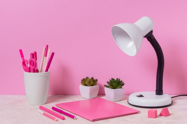 Free photo desk arrangement with pink items