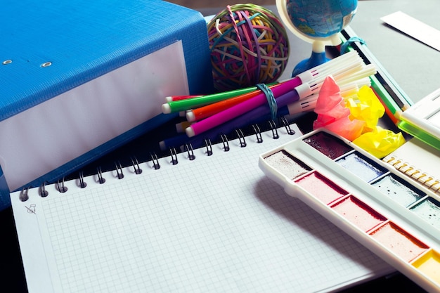 Desk of an artist with lots of stationery objects