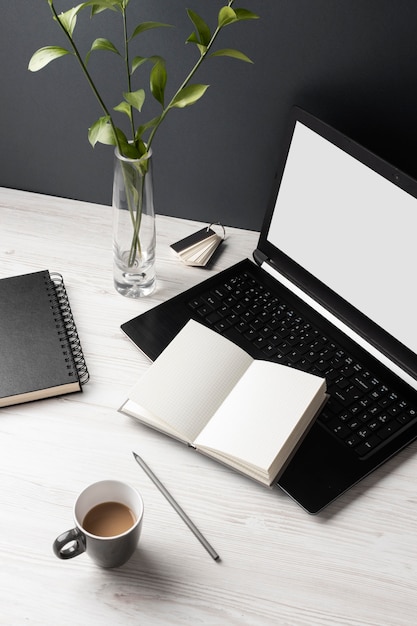 Desk assortment with laptop and notebooks