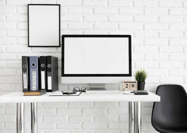 Desk with computer screen and chair