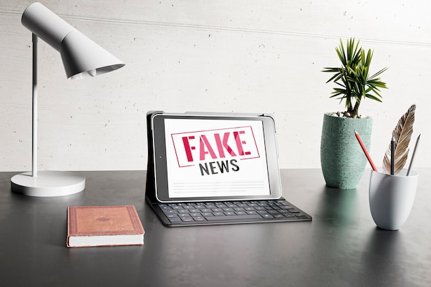 Foto gratuita scrivania con laptop e fake news