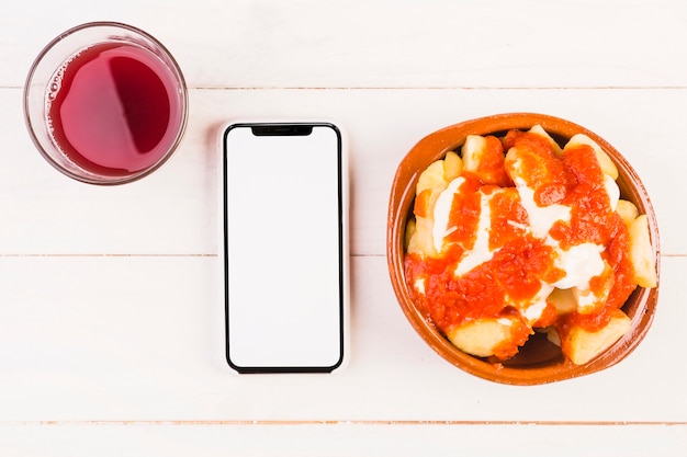 Desktop with drink smartphone and dish