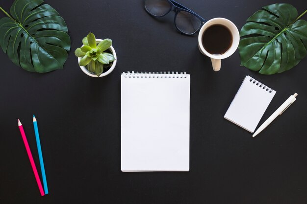 Desktop with notebooks cup and pens