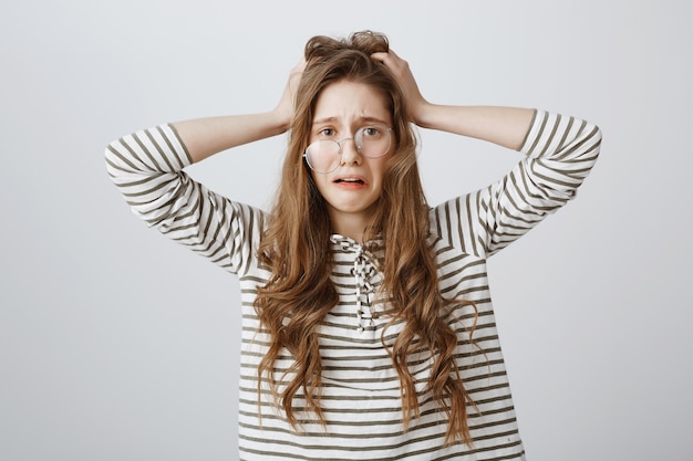 Desperate and upset woman in crooked glasses panicking, got in trouble