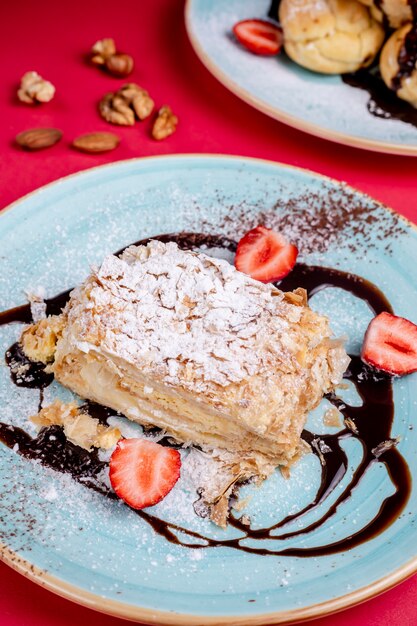 Dessert topped with sugar powder and side strawberries