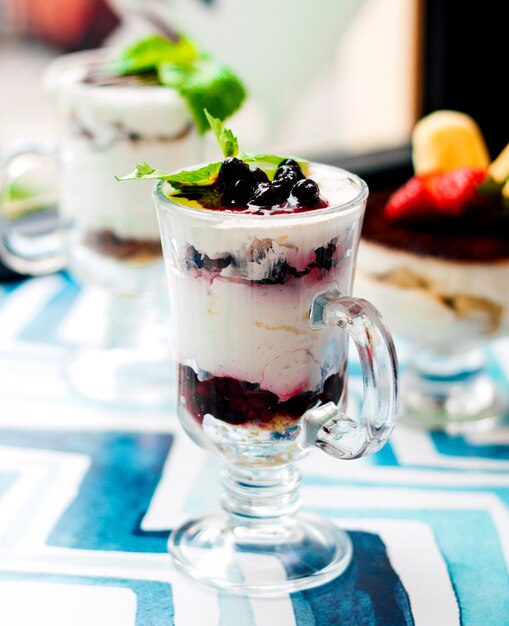 Dessert with cream and berries in glass