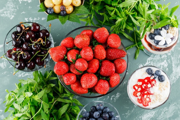 Dessert with strawberry, blueberry, mint, cherry in vase and goblet