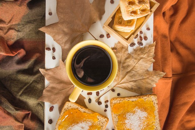 Desserts and leaves near coffee