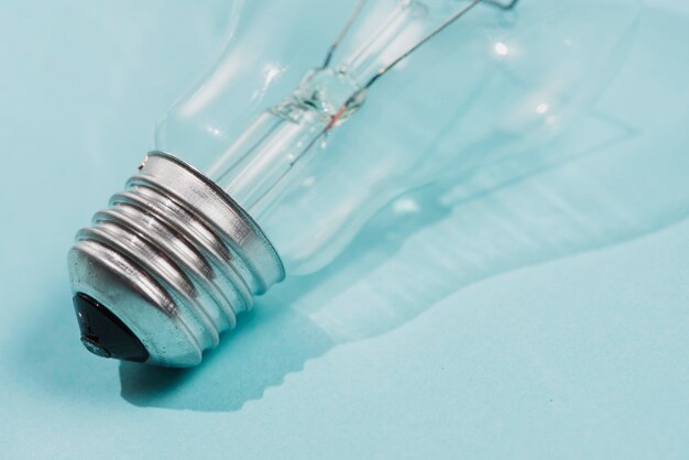 Detail of light bulb on blue backdrop