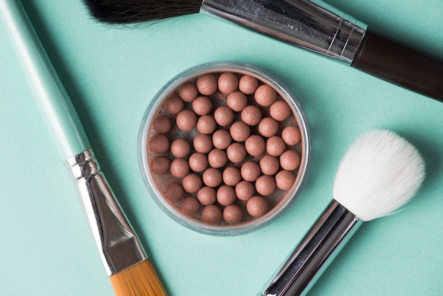 Free photo detail of makeup brush with bronzed pearls