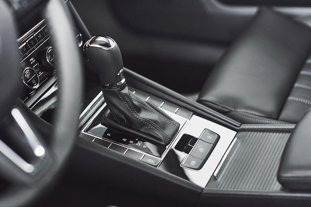 Detail of modern car interior, gear stick, automatic transmission in expensive car.