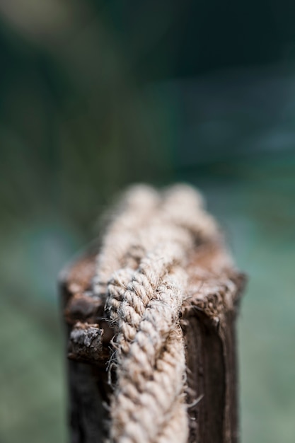 Detail of an old frayed boat rope on wooden post