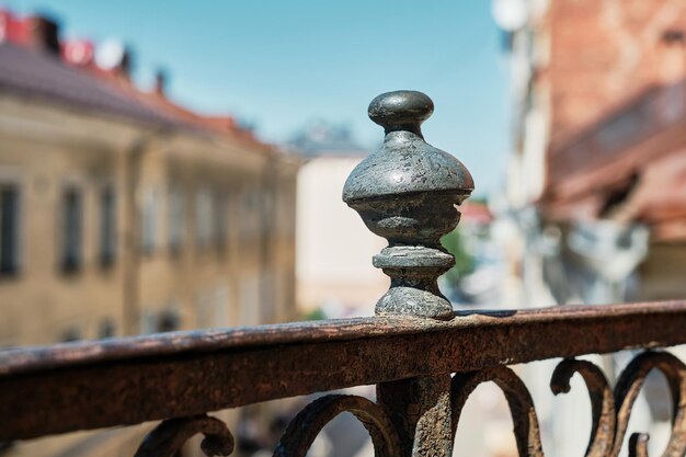 Detail of the openwork lattice of the old balcony on the background of the old city closeup selective focus idea for a banner or background