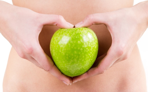 Detail of woman hands holding an green apple