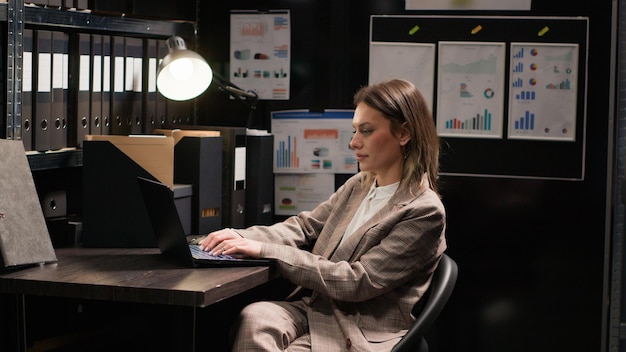 Detective reviewing files in office room