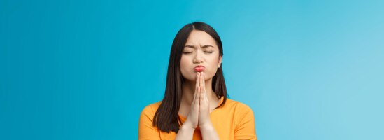 Il sogno di preghiera femminile asiatico sveglio motivato determinato diventa realtà schiaffo mani insieme prega posa vicino e