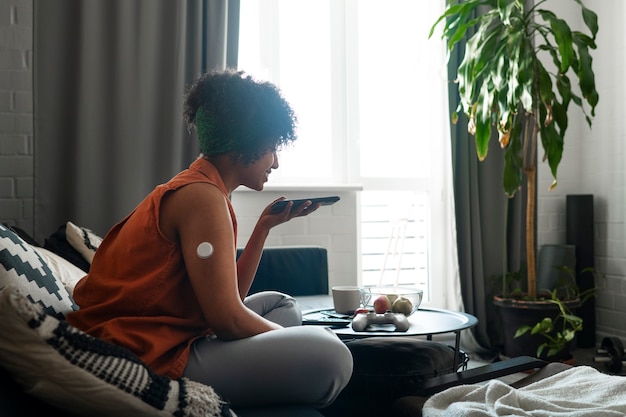 Diabetic woman wearing glucose patch sensor