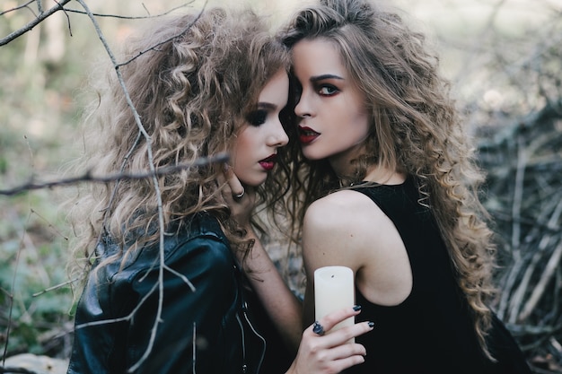 Diabolic teenagers posing with a candle