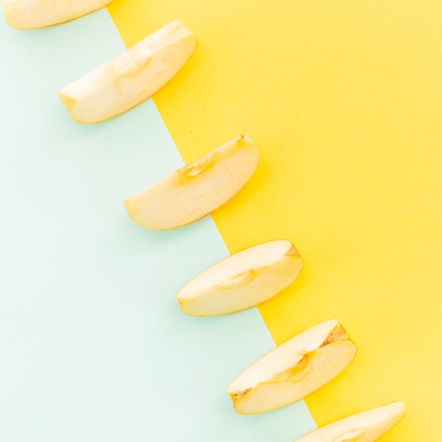 Diagonal of apples slices on colorful background