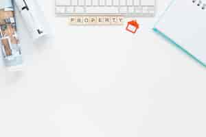 Free photo diary and keyboard with blueprint on white backdrop