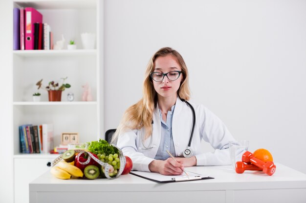 Diet concept with female scientist and healthy food