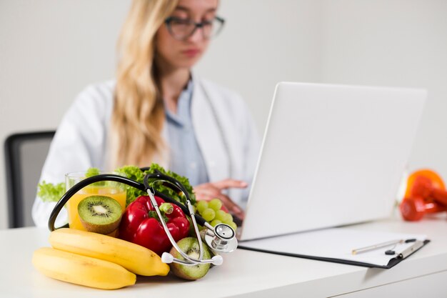 Diet concept with female scientist and healthy food