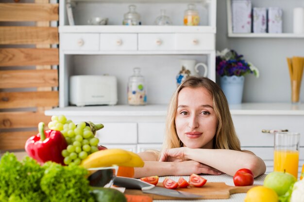 Diet concept with sporty woman in kitchen