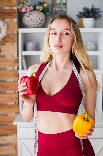 Diet concept with sporty woman in kitchen
