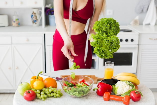 Концепция диеты со спортивной женщиной на кухне