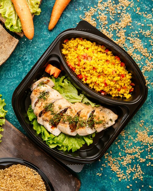  diet food baked chicken breast on lettuce with millet and chopped tomatoes