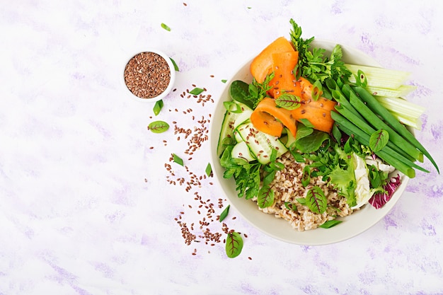 Diet menu. Healthy lifestyle. Oat porridge and fresh vegetables - celery, spinach, cucumber,  carrot and onion  on plate. Flat lay. Top view