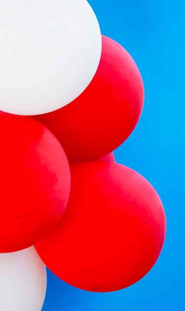 Different balloons on blue background close-up