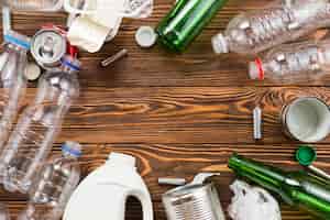 Бесплатное фото Различные бутылки и мусор для переработки на столе