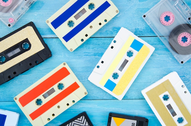 Different cassette tape collection on wooden surface