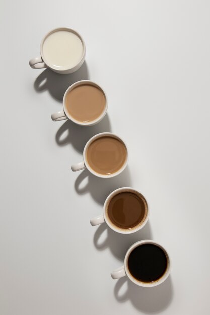 Different coffee cups arrangement flat lay