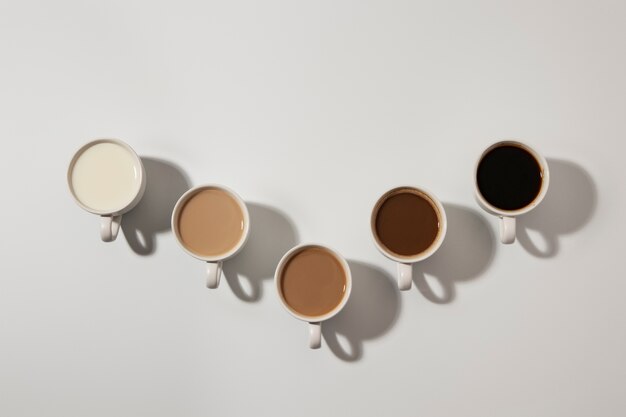 Different coffee cups arrangement top view