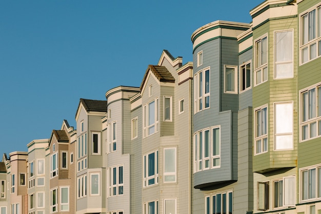 Different color apartments near each other with a clear sky